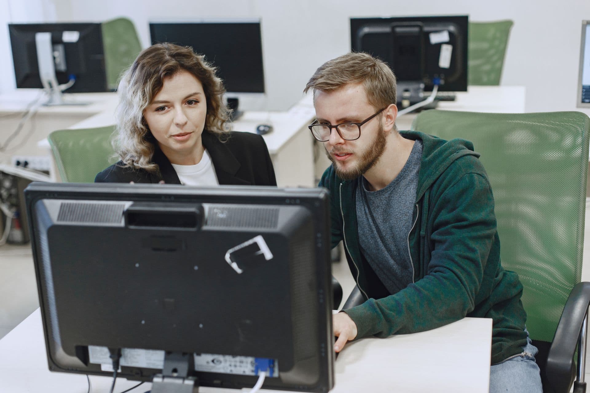 IT support technician helping at a business computer