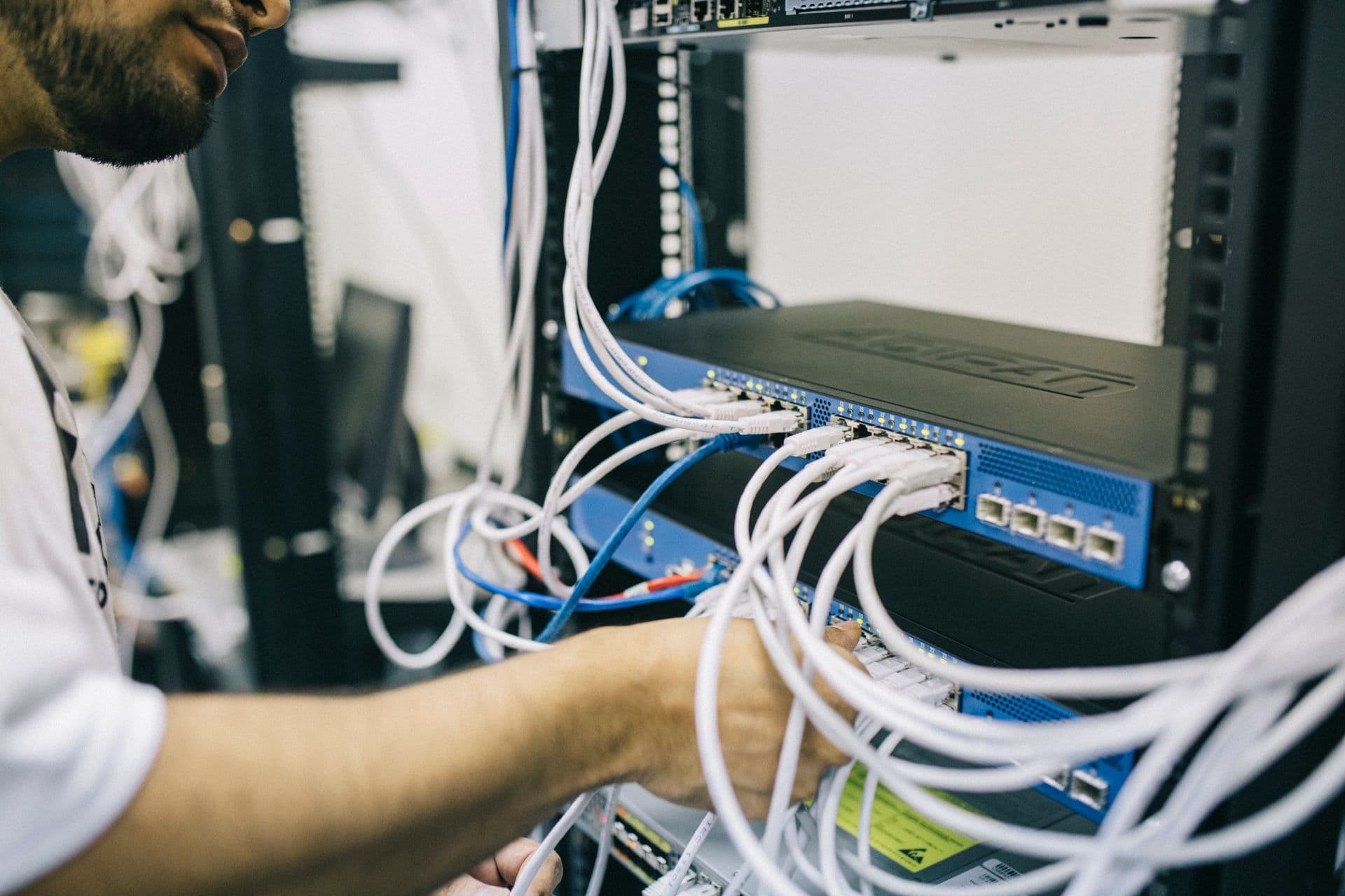 Technician working on a business server rack
