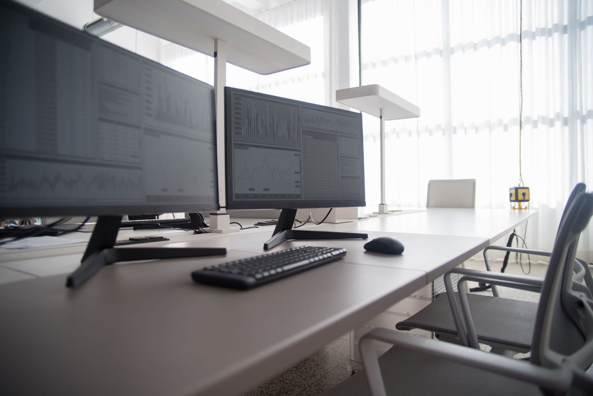 Modern office workspace with dual-monitor computer setups